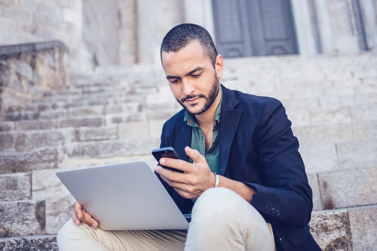 Man sitting looking at mobile phone